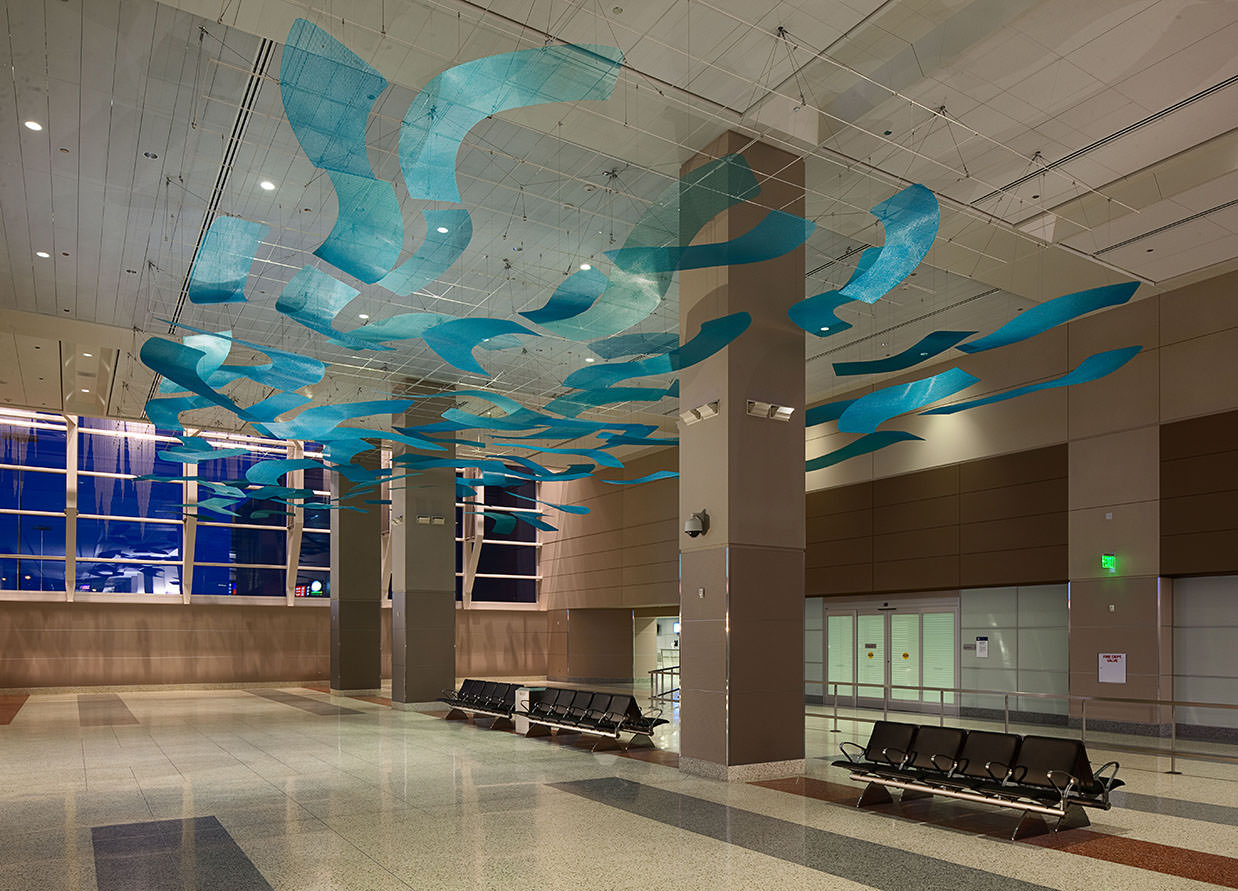 Blue Arroyo public art sculpture by Talley Fisher in a concourse in McCarran International Airport
