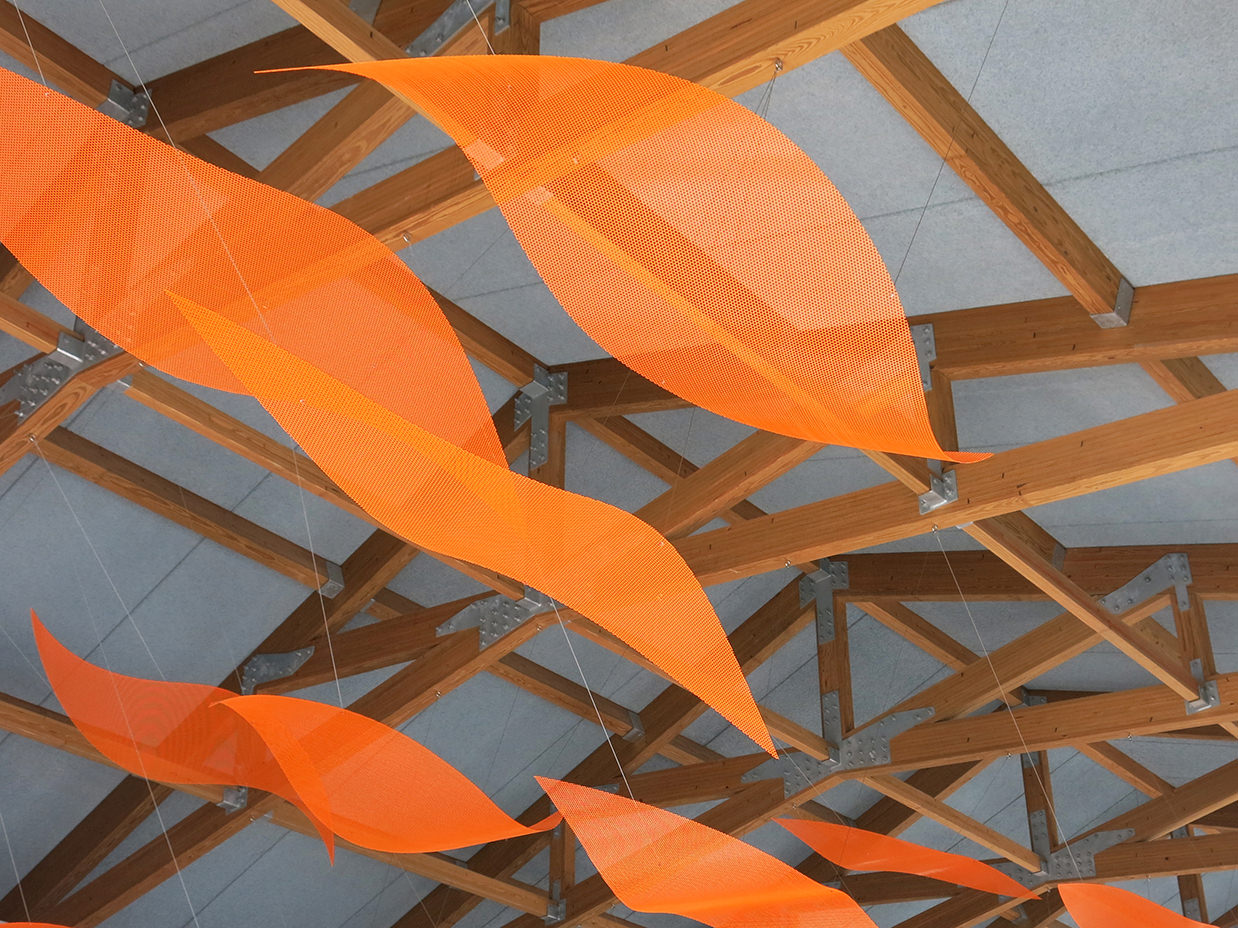 Orange petals of the suspended sculpture by Talley Fisher in Aurora Health and Wellness Center.
