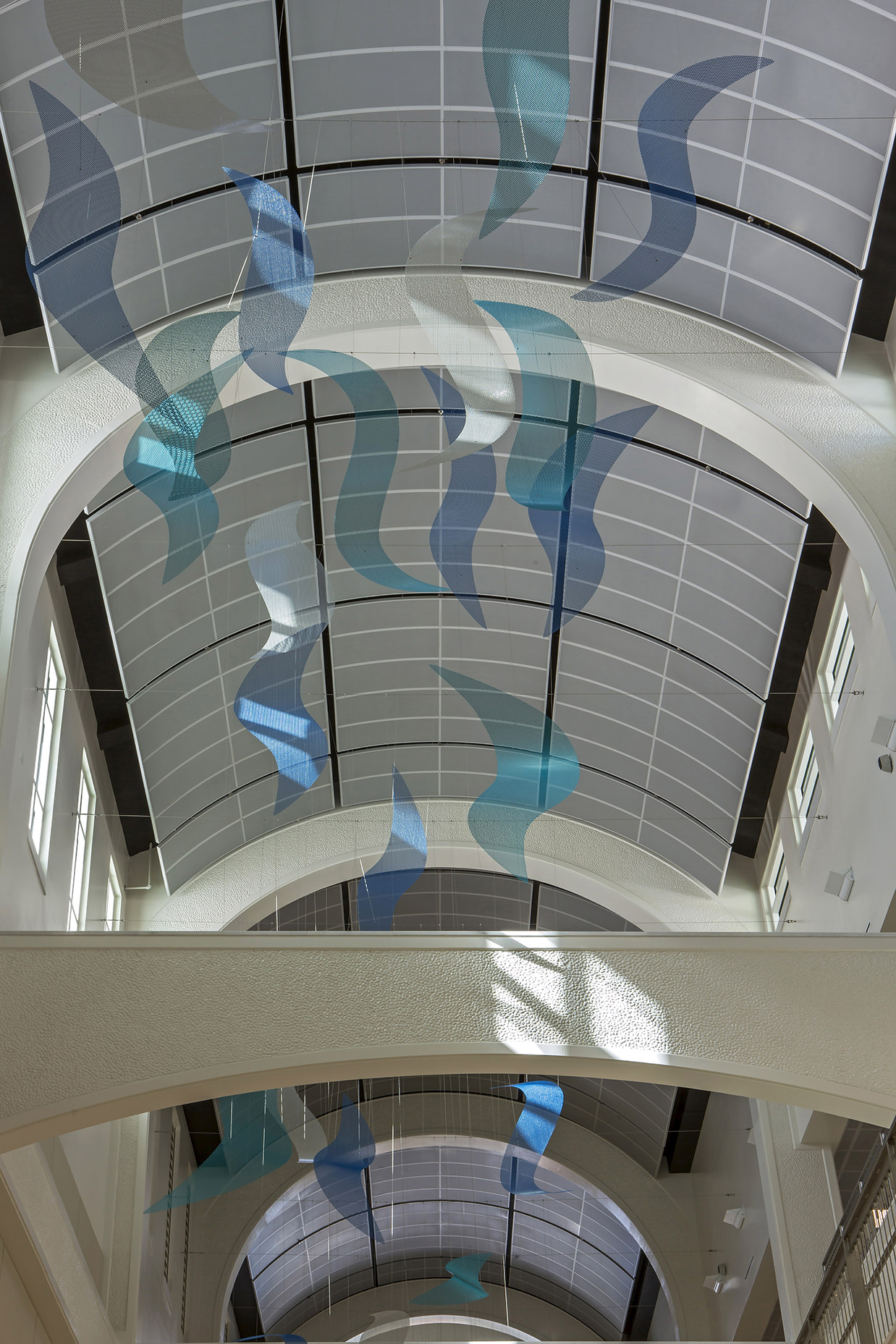 Sunlight hitting wave elements of Talley Fisher's Sea Change in US Naval Hospital, Guam.