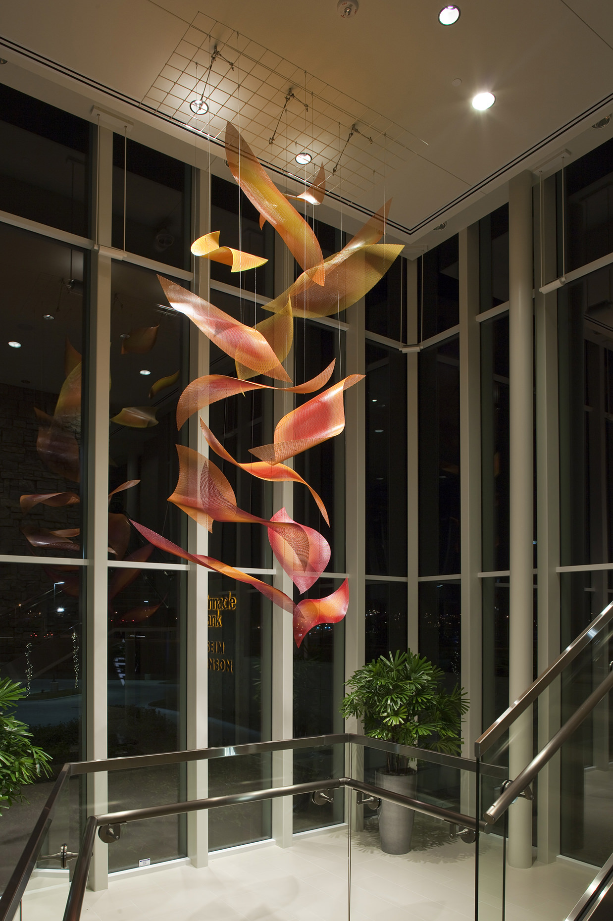 Night view of Sunrise Cascade suspended sculpture by Talley Fisher in Pinnacle Bank Headquarters