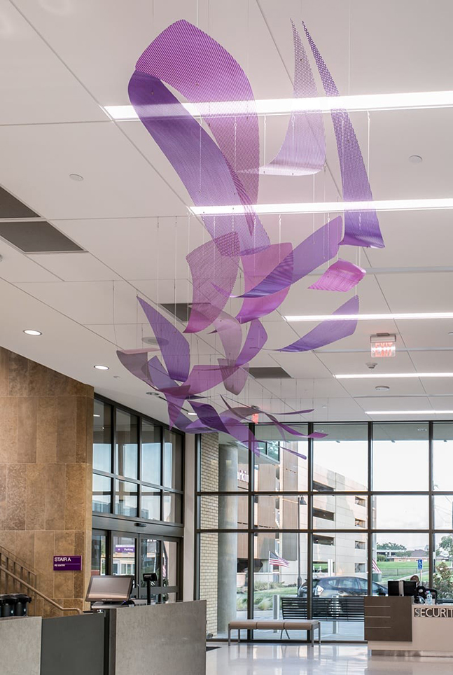 Faith Flows suspended metal sculpture in a hospital atrium.